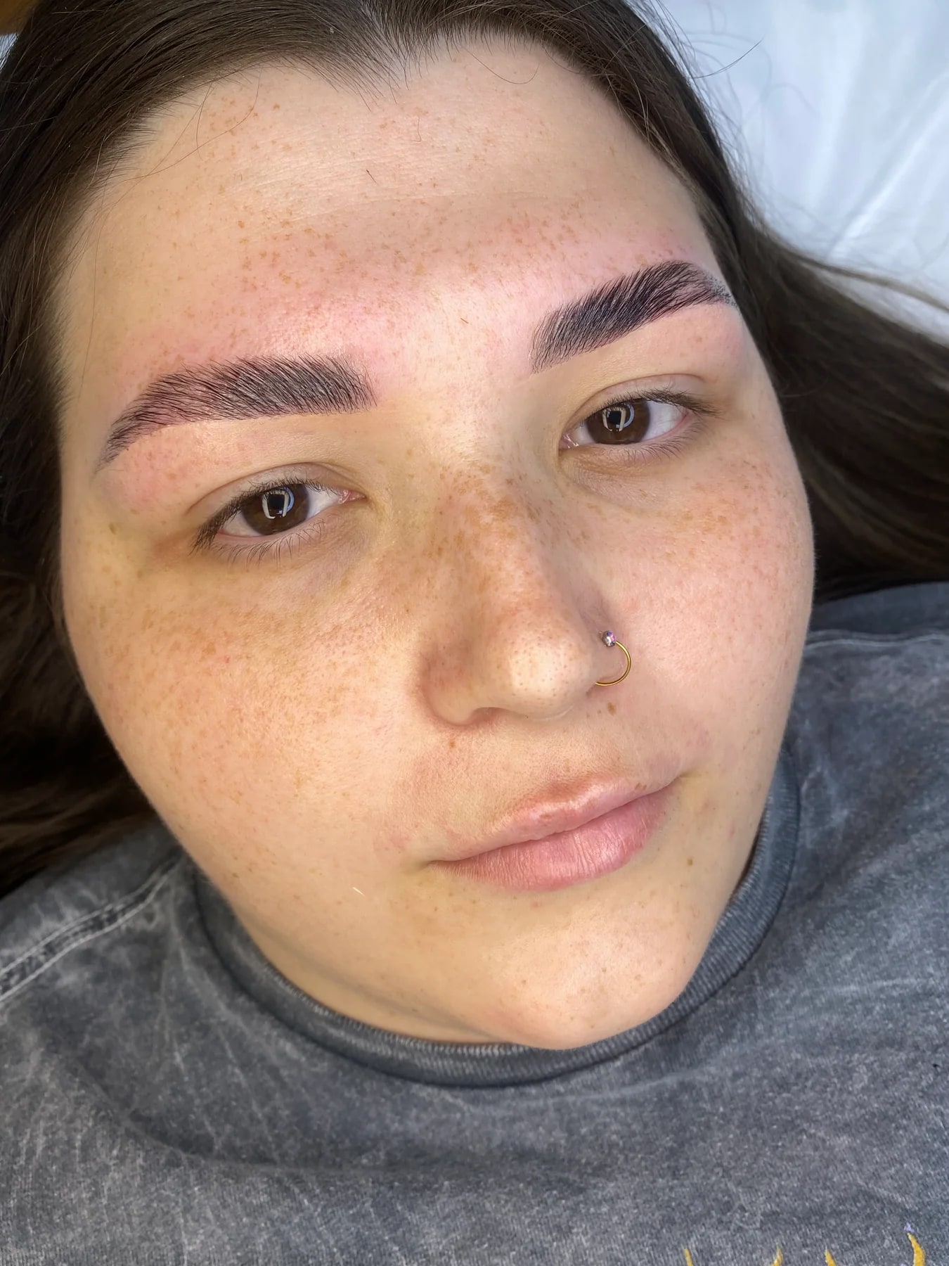 Client showing a customized cosmetic brow result